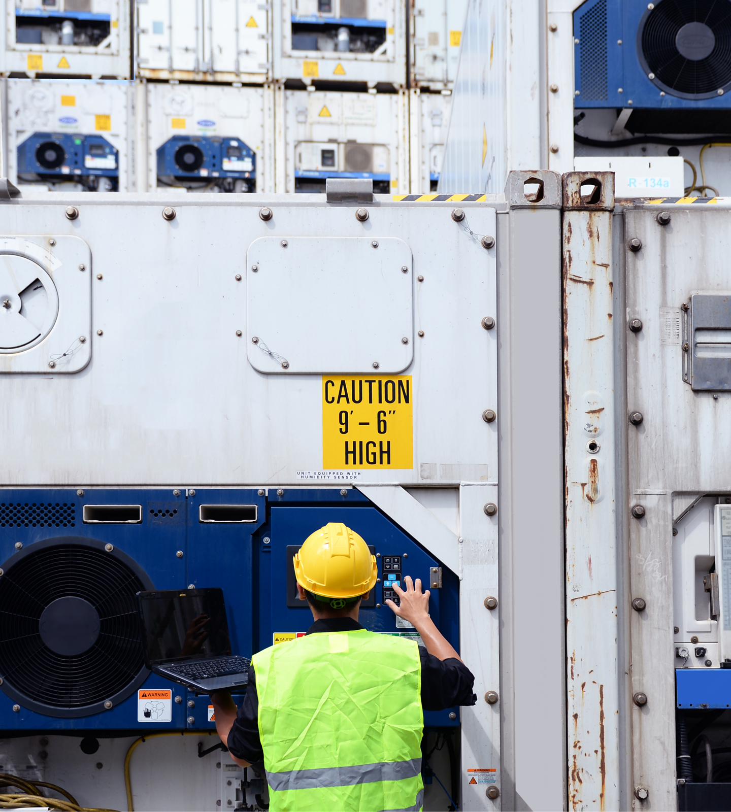 A logistics worker operating a sizable temperature-controlled cargo apparatus.