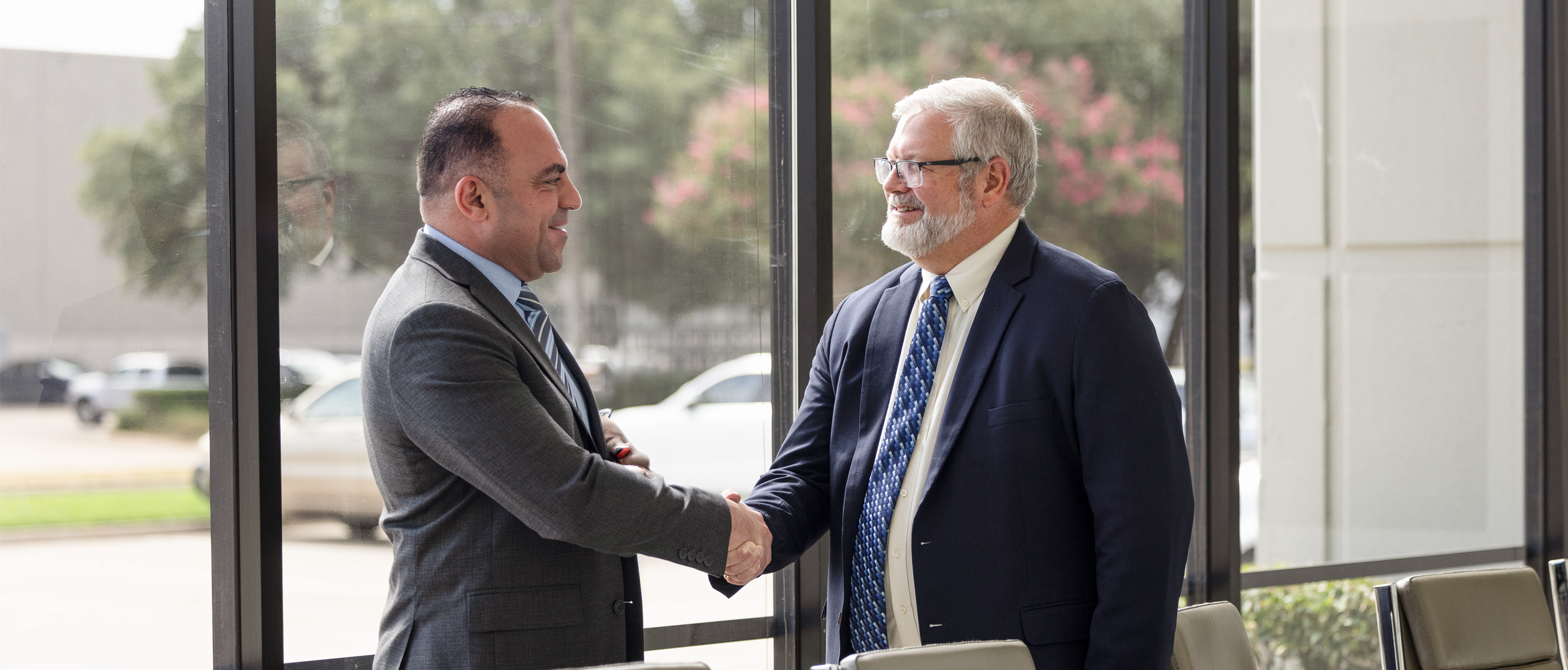 Two business professionals shaking hands at the start of their collaboration and partnership.