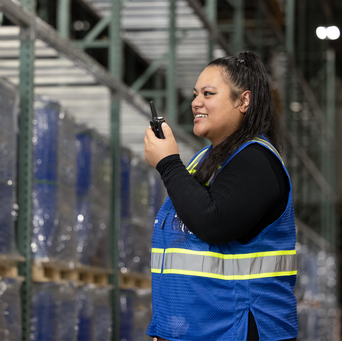 A Morrison warehouse employee  ensuring shipment security on a walkie-talkie.