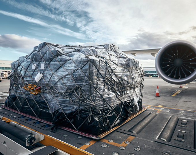 Cargo on a cargo-pallet trailer waiting to be loaded onto the plane. 