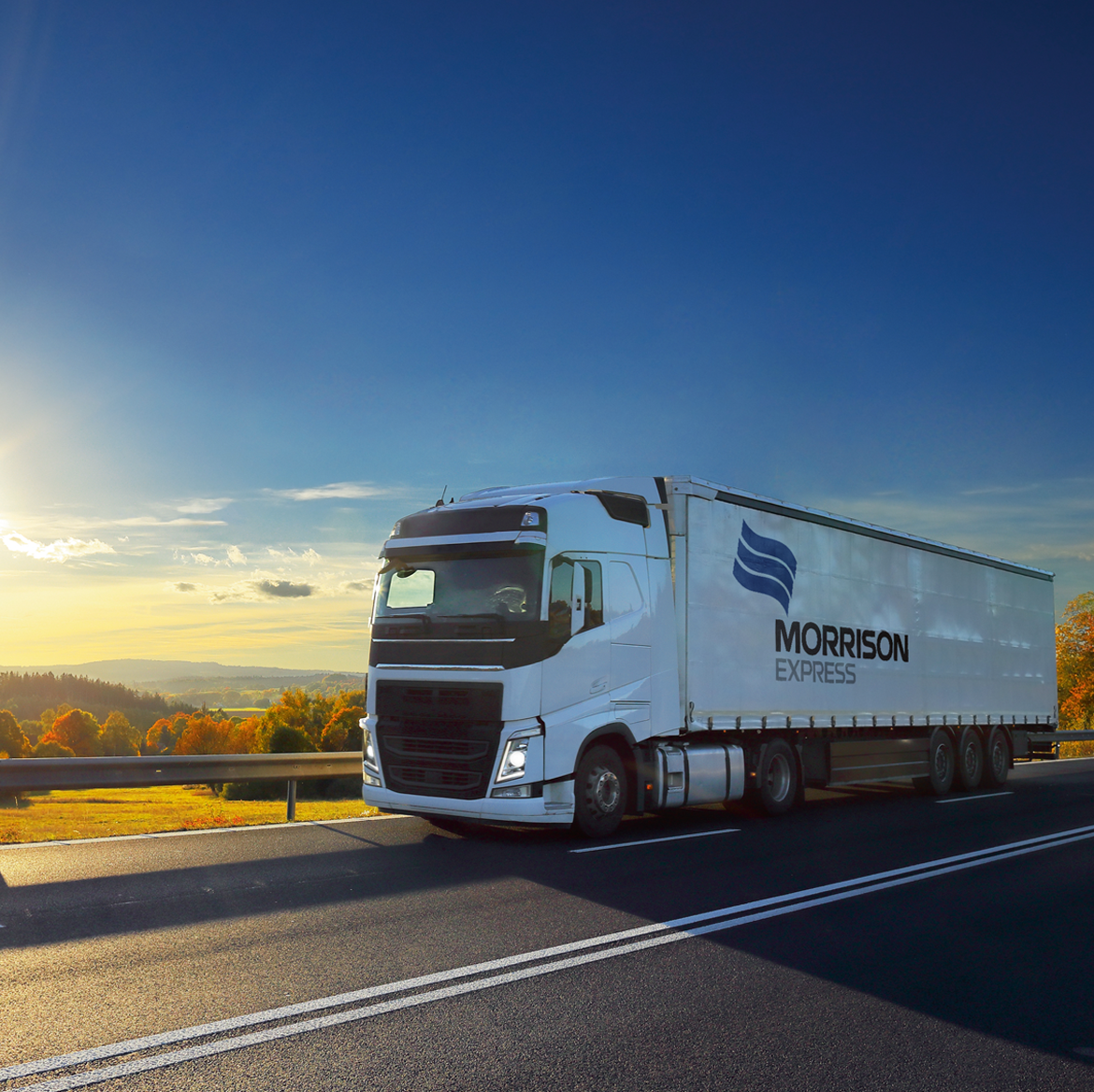 A Morrison branded semi-trailer truck driving on the highway.