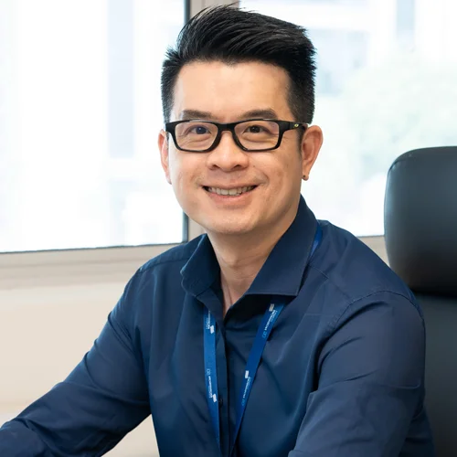 A Morrison employee seated in his office smiling. 